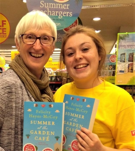 Author Felicity Hayes-McCoy and an Easons book shop staff member with copies of her Finfarran novel, Summer at the Garden Café, on a 2017 signing tour of Ireland