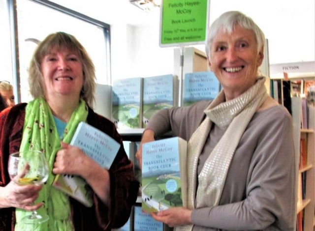 Audiobook voice artist Marcella Riordan (l) and USA Today bestselling Irish author Felicity Hayes-McCoy (r) holding copis of Hachette Irl's edition of The Transatlantic Book Club, at its Irish launch, hosted by The Gutter Bookshop, Dublin